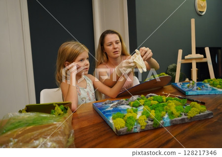 A mother and her daughter craft vibrant natural landscapes A mother and her daughter craft vibrant natural landscapes 128217346