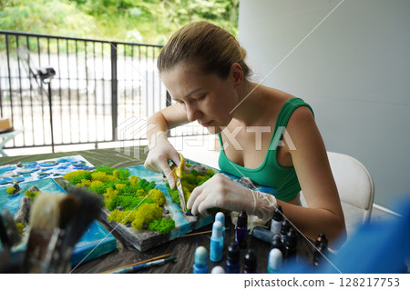 The process of making the art decor of epoxy resin, natural stones and moss 128217753