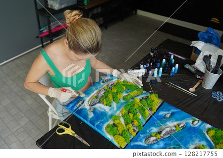 The process of making the art decor of epoxy resin, natural stones and moss 128217755