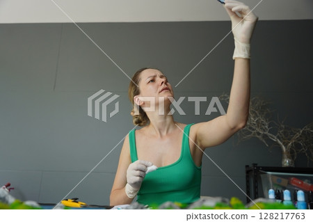The process of making the art decor of epoxy resin, natural stones and moss 128217763