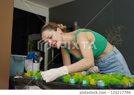 The process of making the art decor of epoxy resin, natural stones and moss 128217766