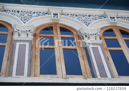 Detailed view of windows, doors and balconies of city buildings  128217839
