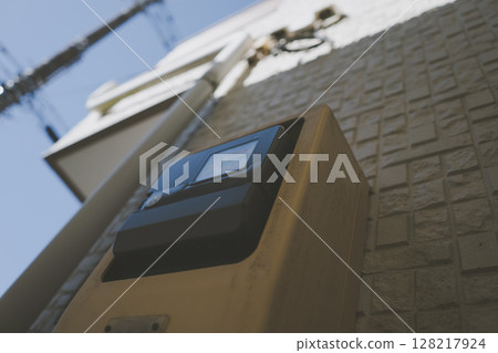 A smart meter installed on the exterior wall of a house 128217924