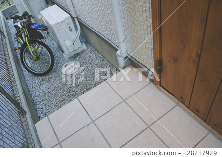 Entrance of a detached house and children's bicycle 128217929