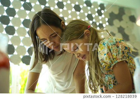 Teacher in workshop teched two girls how to assemble a thermo mosaic  128218039