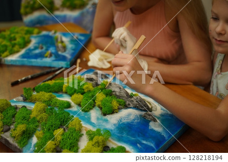 A mother and her daughter craft vibrant natural landscapes A mother and her daughter craft vibrant natural landscapes 128218194