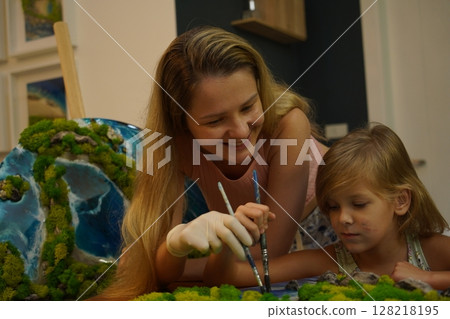 A mother and her daughter craft vibrant natural landscapes A mother and her daughter craft vibrant natural landscapes 128218195