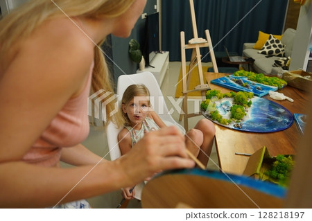 A mother and her daughter craft vibrant natural landscapes A mother and her daughter craft vibrant natural landscapes 128218197