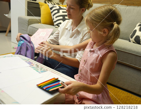 A mother supports her daughter with homework 128218218