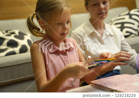 A mother supports her daughter with homework A mother supports her daughter with homework 128218220