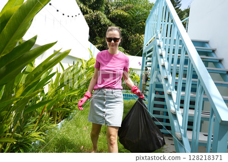 A young woman trims her beautiful garden  128218371