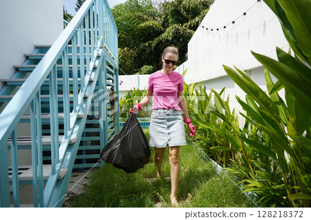 A young woman trims her beautiful garden  128218372