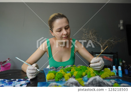 The process of making the art decor of epoxy resin, natural stones and moss The process of making the art decor of epoxy resin, natural stones and moss 128218503