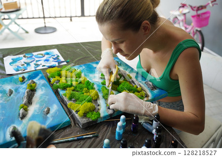 The process of making the art decor of epoxy resin, natural stones and moss The process of making the art decor of epoxy resin, natural stones and moss 128218527