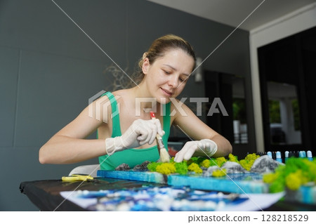 The process of making the art decor of epoxy resin, natural stones and moss The process of making the art decor of epoxy resin, natural stones and moss 128218529