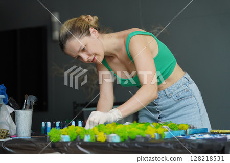The process of making the art decor of epoxy resin, natural stones and moss 128218531
