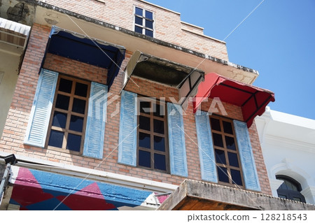 Detailed view of windows, doors and balconies of city buildings  128218543