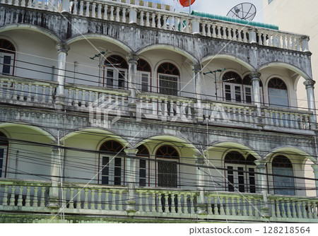 Detailed view of windows, doors and balconies of city buildings  128218564