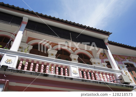 Detailed view of windows, doors and balconies of city buildings  128218573