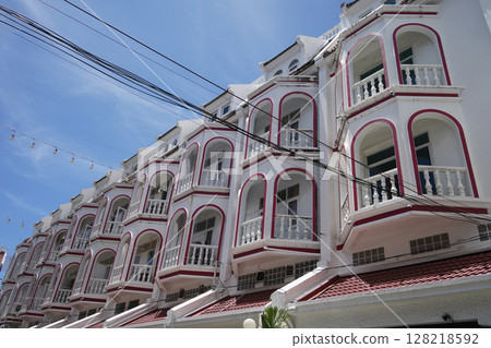 Detailed view of windows, doors and balconies of city buildings  128218592