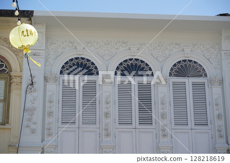 Detailed view of windows, doors and balconies of city buildings  128218619