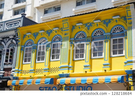 Detailed view of windows, doors and balconies of city buildings  128218684