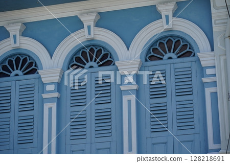 Detailed view of windows, doors and balconies of city buildings  128218691