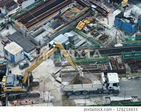 An aerial perspective showcasing a construction site located in a bustling city 128218833