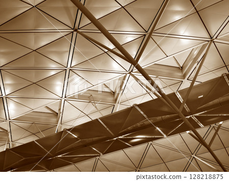 The large glass ceiling of an expansive modern building 128218875