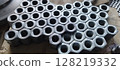 Flanged steel hex nuts stacked on the table. Tool. Steel Screw Nuts. Hex nuts in a pattern. Mechanical engineering. Is used in such fields as mechanical engineering, oil and gas, metallurgy, chemical, 128219332