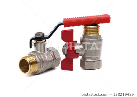 Two ball valves with brass fittings and red and black handles isolated on a white backdrop. 128219489