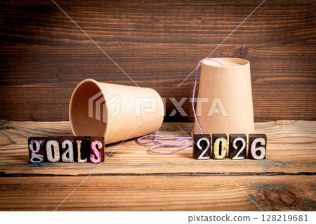 2026 Goals Concept. Paper Cup Phone on Wooden Table 128219681