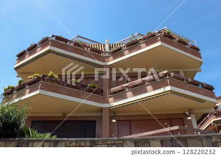 Modern apartment building with spacious balconies. Urban architecture concept Modern apartment building with spacious balconies. Urban architecture concept 128220232