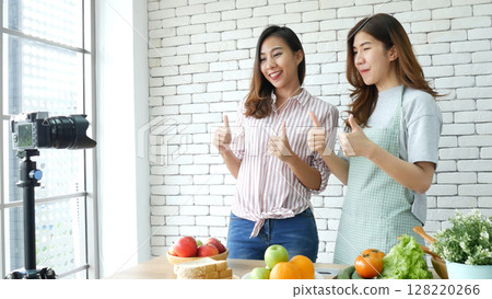 Asian influencer vlogger live review tomato skin care healthy eating lifestyle. Two Young Women Friends blogger vlog Happy Lifestyle vitamin C tomato vegetable fruit. Vlog Two women talk social media Asian influencer vlogger live review tomato skin care healthy eating lifestyle. Two Young Women Friends blogger vlog Happy Lifestyle vitamin C tomato vegetable fruit. Vlog Two women talk social media 128220266