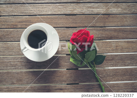 Tabletop black coffee cup red rose on wood table background with empty copy space. Espresso shot caffeine hot coffee cup in cafe. Top view Black caffeine dark beverage in cafeteria with copy space 128220337