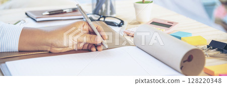 Banner Businesswoman hands note meeting document in conference room. Woman Hands writing planning on notebook. Female hand holding pencil write on diary sketchbook. Business Planning with copy space Banner Businesswoman hands note meeting document in conference room. Woman Hands writing planning on notebook. Female hand holding pencil write on diary sketchbook. Business Planning with copy space 128220348