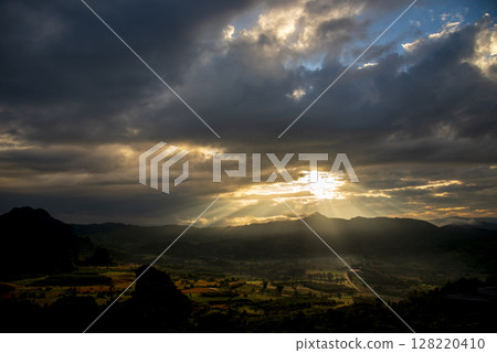 Scenic view dramatic beautiful sunset sky. Natural Sunset Sunrise on meadow silhouette shadow dark land. Vibrant dramatic sky on sunset, dawn, sunrise in Countryside. Landscape Colorful Sky At Sunset 128220410