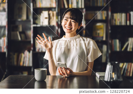Young Asian women meeting and greeting each other at a cafe, coffee shop Young Asian women meeting and greeting each other at a cafe, coffee shop 128220724