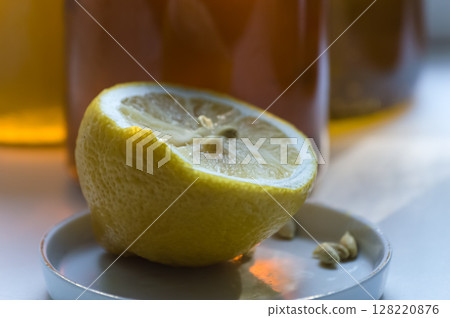 Lemon and honey in a glass jar on a white background. Lemon and honey in a glass jar on a white background. 128220876