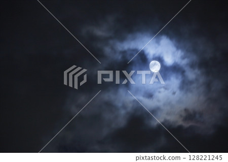 A full moon emerging from the clouds on a winter night 128221245