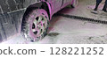 Car wash close-up with white and vibrant pink foam covering the vehicle. Self-service station. Cleaning process. Perfect for auto care, maintenance, and service concepts. Advertising. 128221252