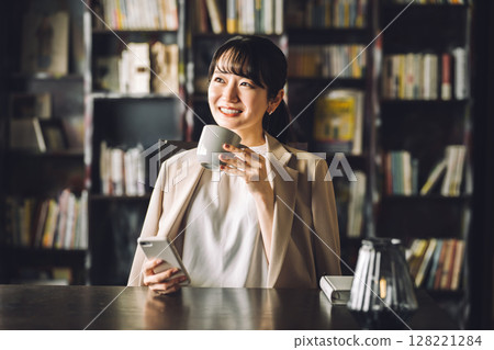 E-book, study, smartphone in library, Asian woman using smartphone, business woman 128221284