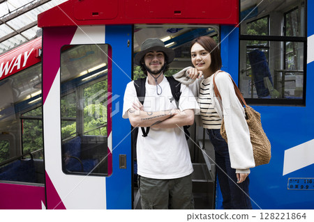 Tourists riding a cable car 128221864
