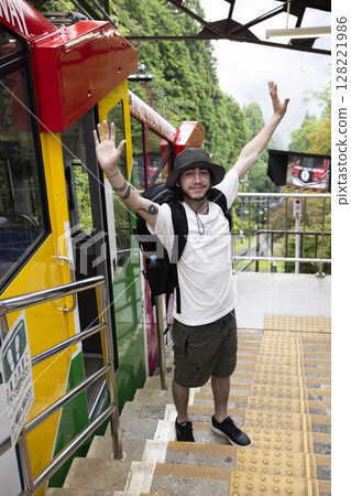 Tourists riding a cable car Tourists riding a cable car 128221986