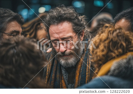 Group therapy and support - middle aged men and women hug, supporting each other during psychological practice. A moment of compassion captured as participants hug during therapy. 128222020