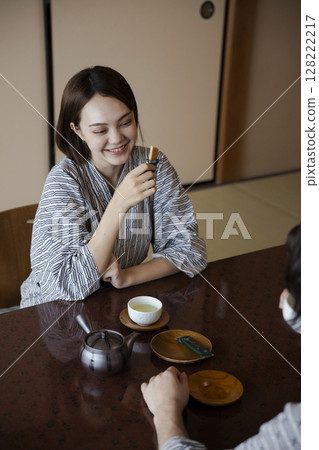 Travelers drinking tea at a ryokan 128222217