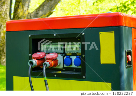 Close-Up of Power Generator Panel with 230V Sockets and Cables in Outdoor Energy Setup 128222287