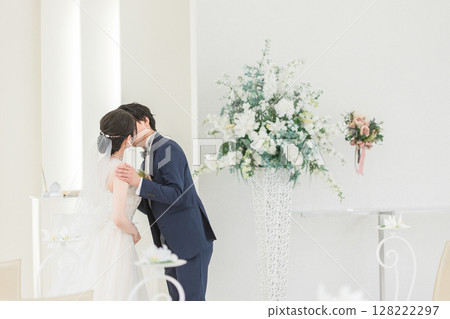 Bride and groom kissing at wedding ceremony (mouth, lips) 128222297