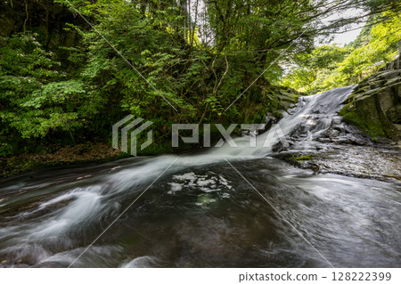 A clear waterfall flowing in summer A clear waterfall flowing in summer 128222399