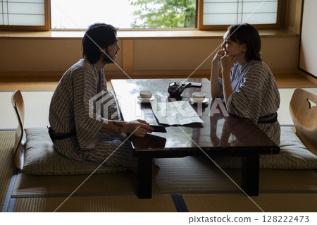 A young couple relaxing at a ryokan 128222473
